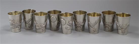 A set of nine early 20th century Chinese Export white metal tots, by Zee Wo, each decorated with a dragon, 13 oz.
